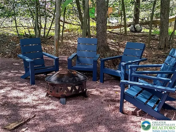 a wooden bench sitting in the middle of a yard