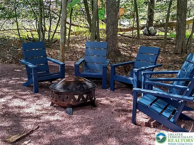 a wooden bench sitting in the middle of a yard