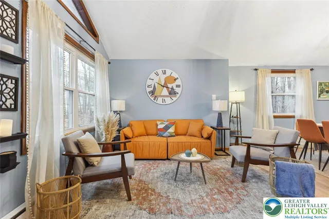 a living room with furniture and a large window