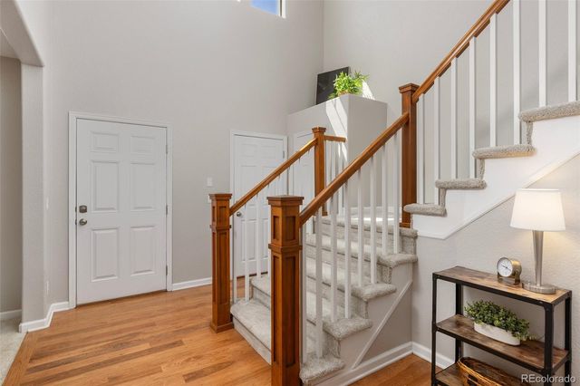 a view of entryway with wooden floor and stairs