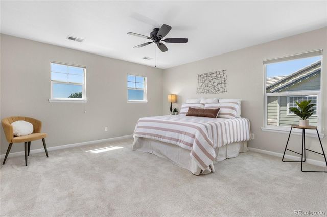 a bedroom with a bed a lamp and a chandelier