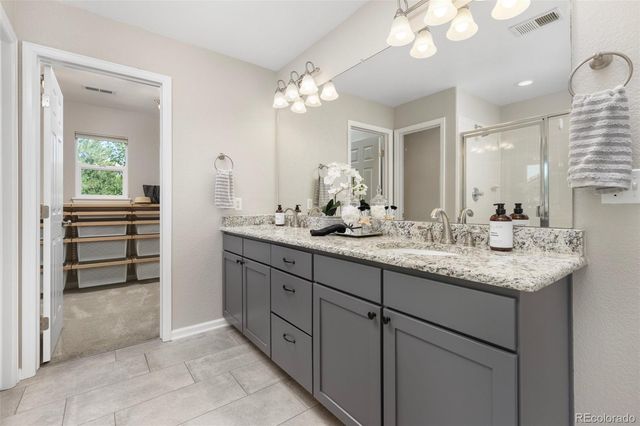 a bathroom with a sink double vanity and a mirror