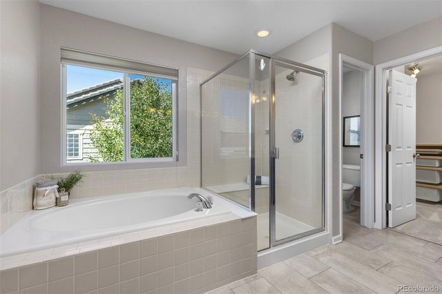 a bathroom with a bathtub shower and a sink