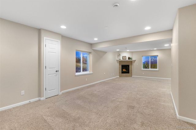 a view of a big room with windows and fireplace