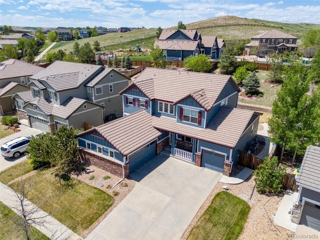 an aerial view of a house with swimming pool and a yard