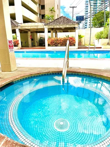 a view of a swimming pool with chairs