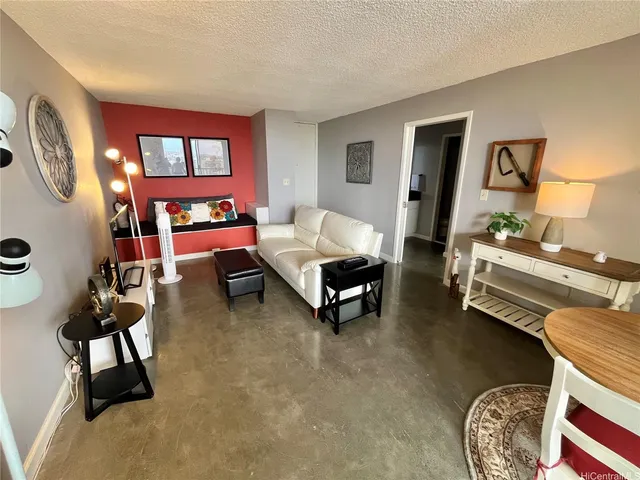 a living room with furniture a rug and a window