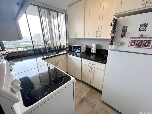 a kitchen with a sink a stove and cabinets