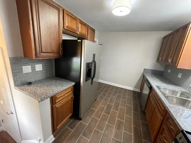 a kitchen with a sink stove and refrigerator
