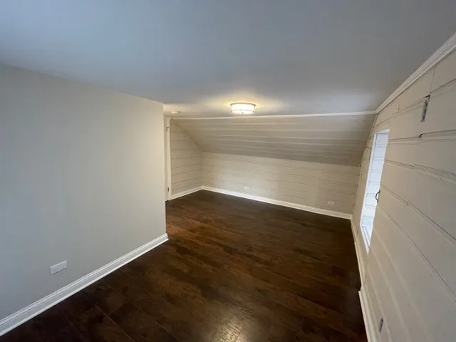 a view of an empty room and wooden floor
