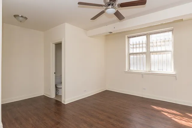 a view of a room with wooden floor and windows