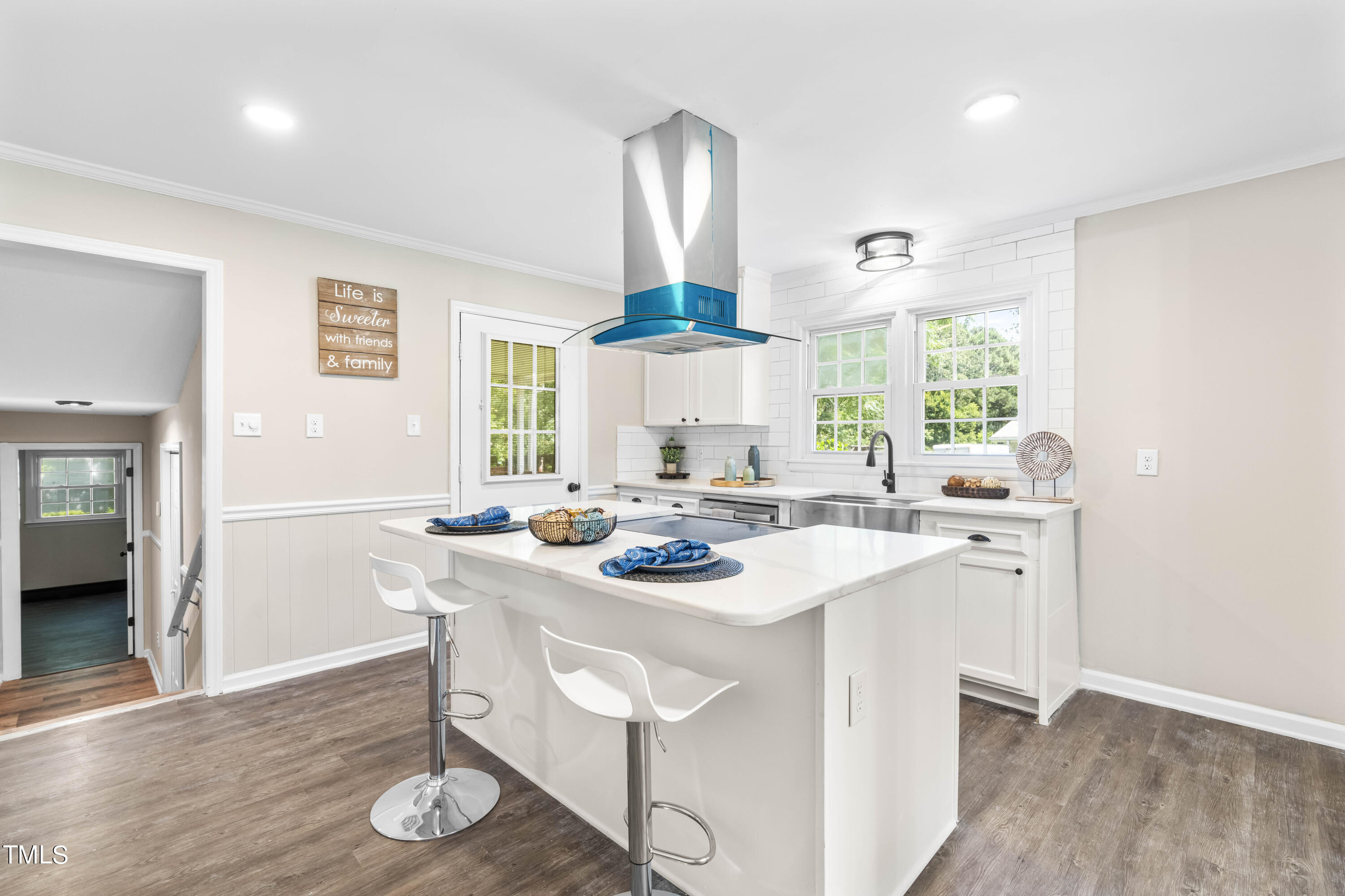 2616 Bullock Road Durham, NC 27704 - Photo 11 of 41 a kitchen with stainless steel appliances a dining table and chairs in it