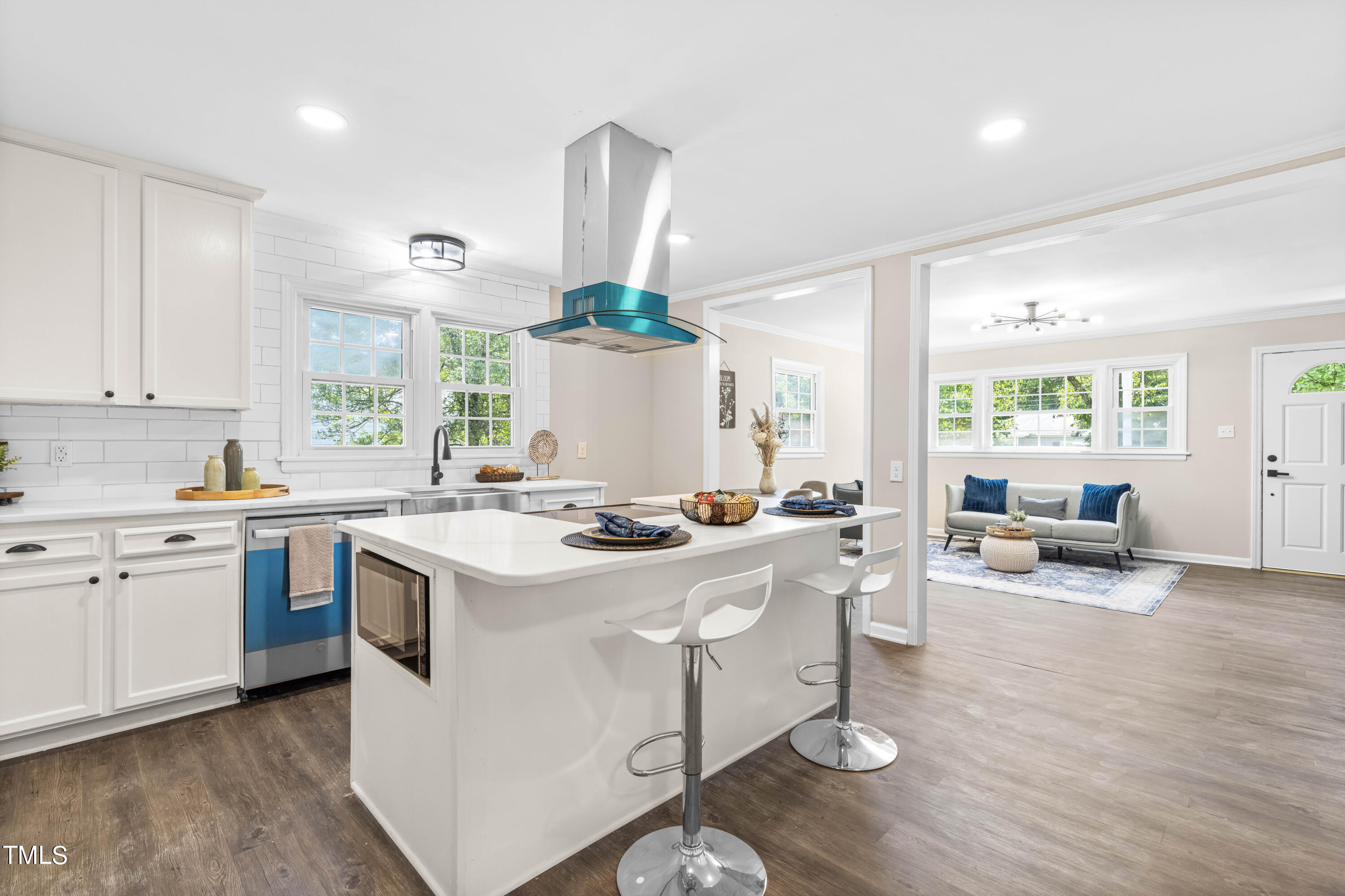 2616 Bullock Road Durham, NC 27704 - Photo 13 of 41 a kitchen with a stove a sink a dining table and chairs
