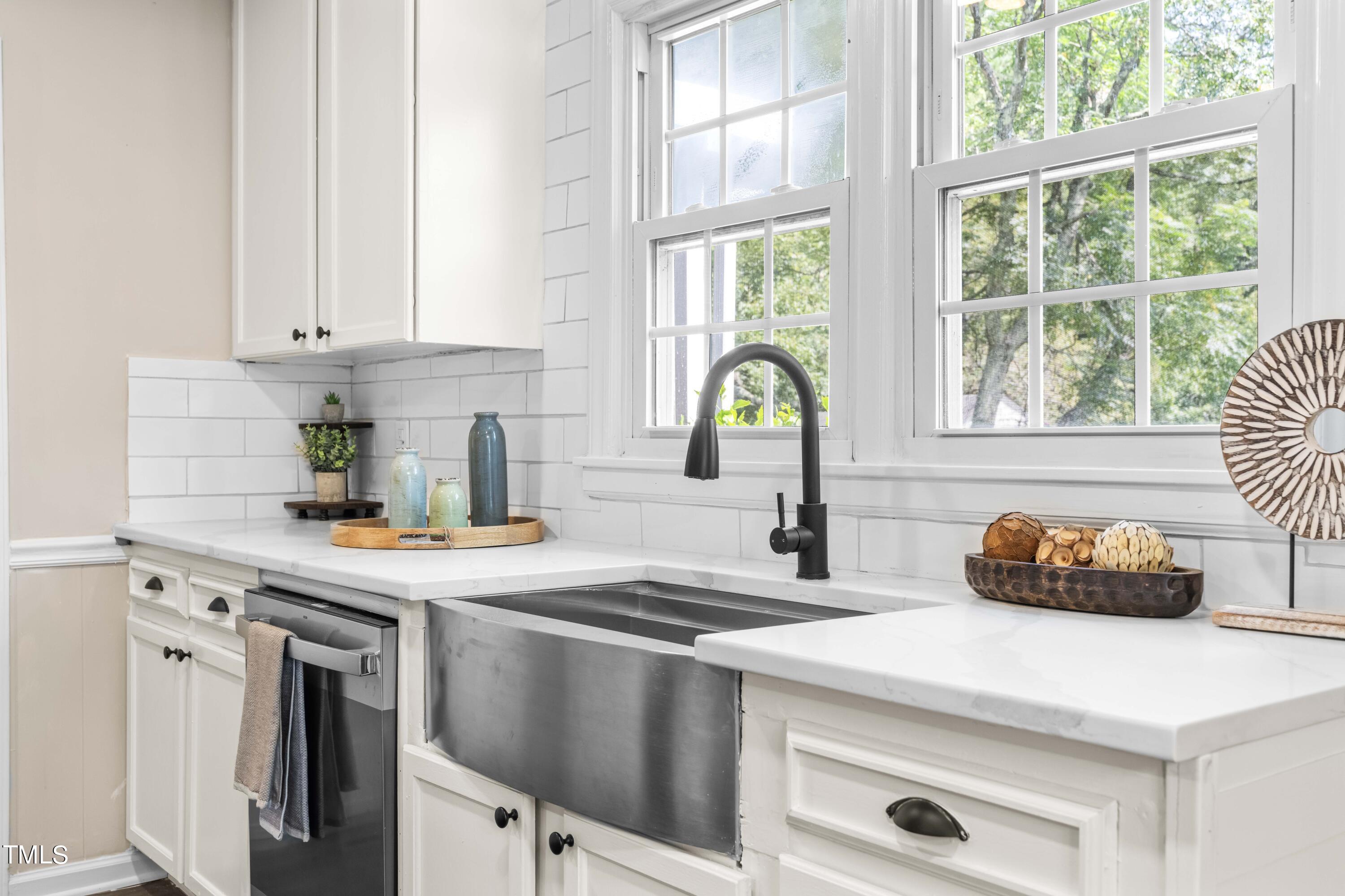 2616 Bullock Road Durham, NC 27704 - Photo 15 of 41 a kitchen with stainless steel appliances a sink a stove a window cabinets and a counter top space