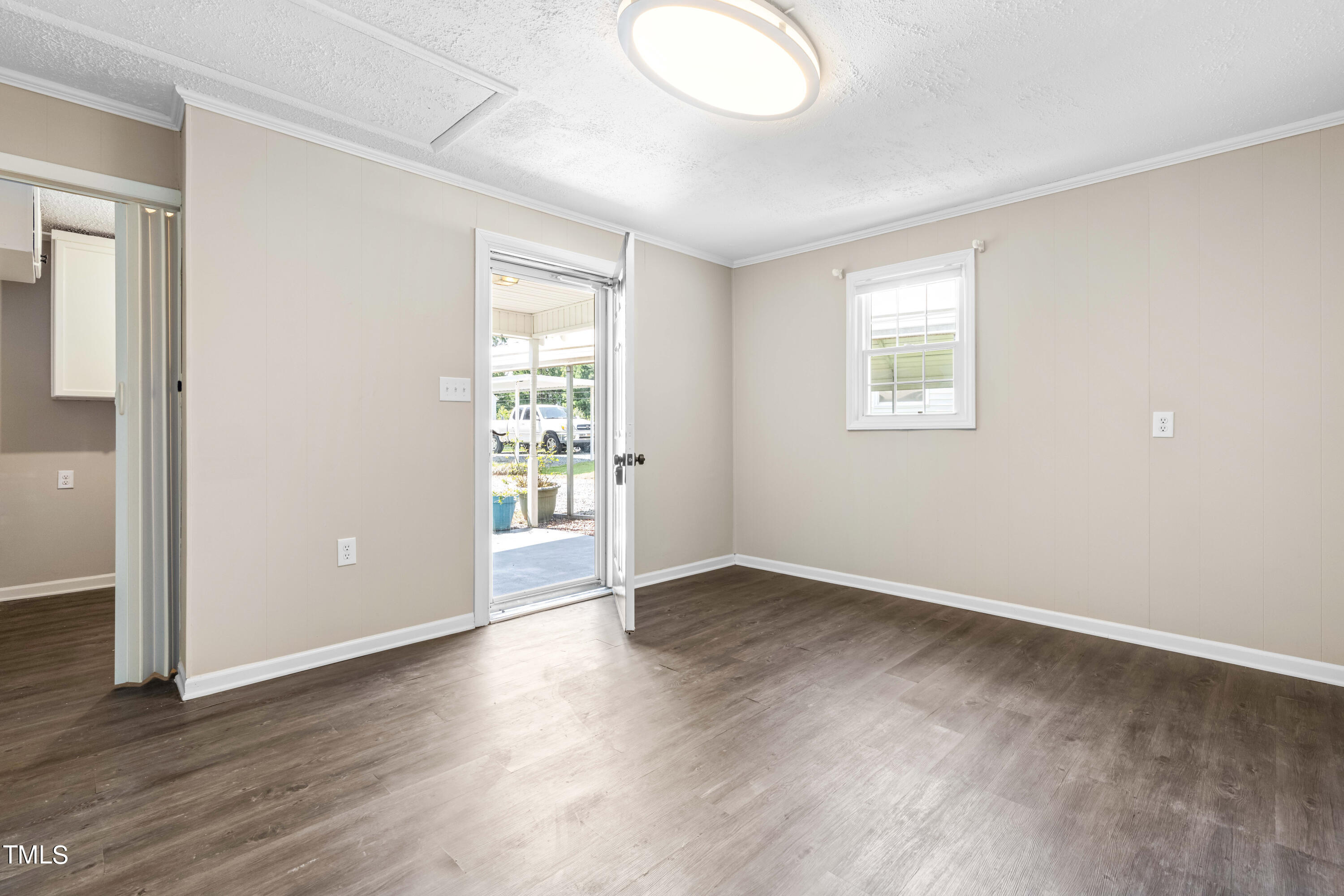 2616 Bullock Road Durham, NC 27704 - Photo 27 of 41 an empty room with wooden floor and windows