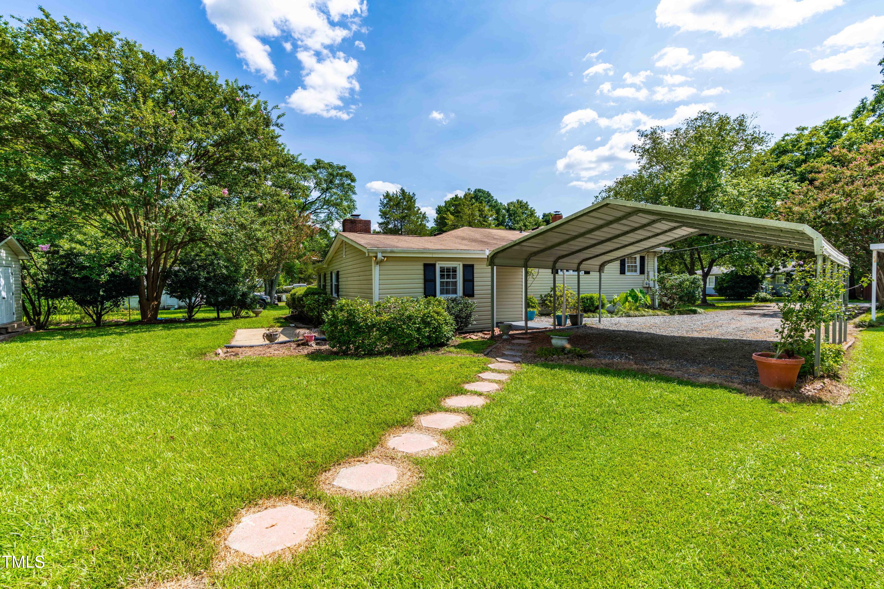 2616 Bullock Road Durham, NC 27704 - Photo 32 of 41 a view of a swimming pool with lawn chairs under an umbrella