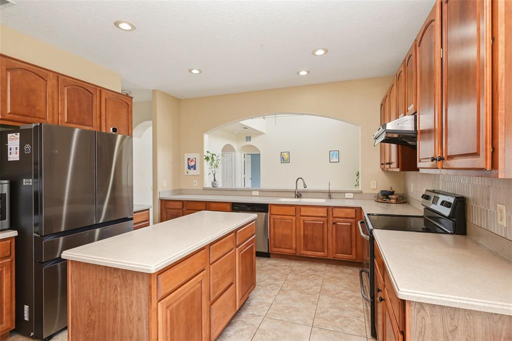 936 Kingsridge Circle Gotha, FL 34734 - Photo 9 of 50 a kitchen with stainless steel appliances a sink stove and refrigerator