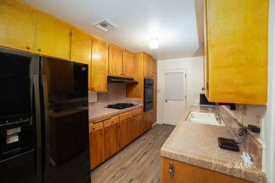315 East Robertson Road Ridgecrest, CA 93555 - Photo 3 of 27 a kitchen with stainless steel appliances granite countertop a sink stove and refrigerator