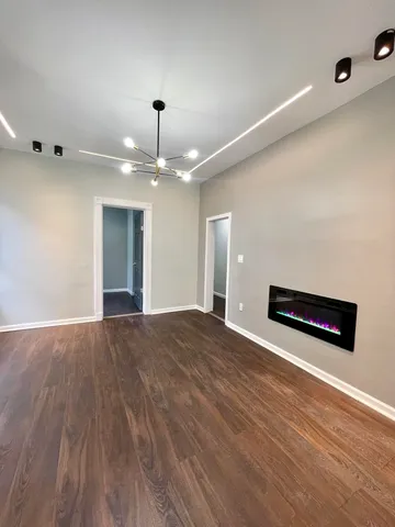a view of an empty room and wooden floor