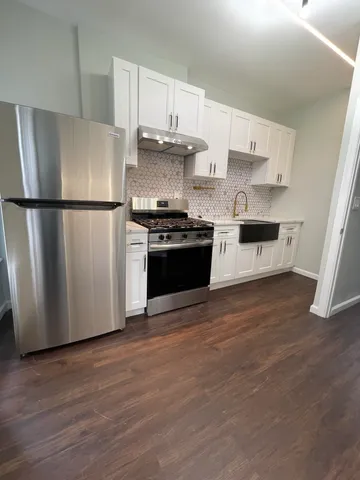 a kitchen with stainless steel appliances a refrigerator a stove a microwave and cabinets