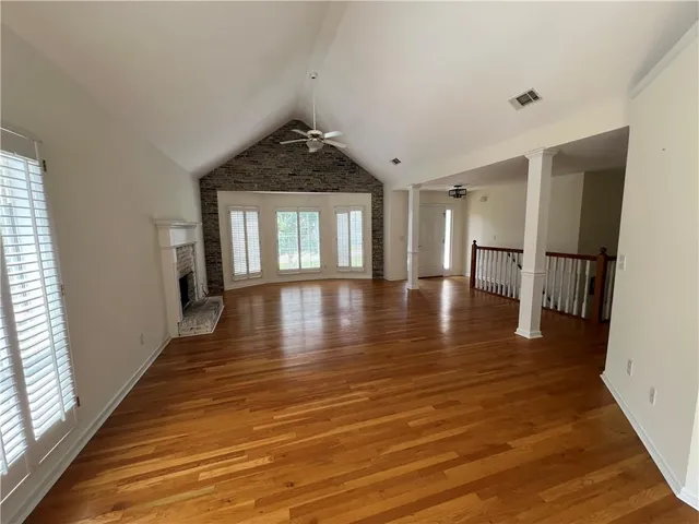 a view of a room with wooden floor and a window