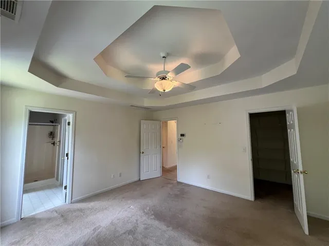 a view of an empty room with a ceiling fan