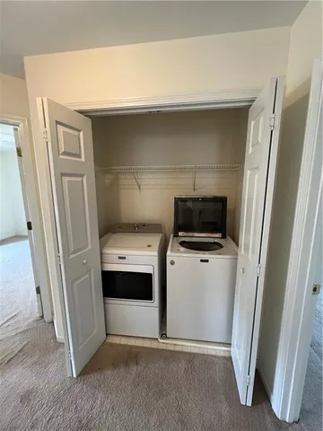 a view of storage and utility room with a refrigerator