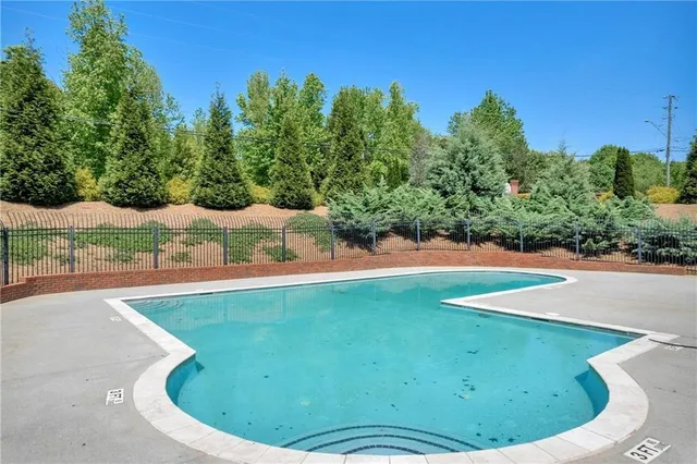 a view of a swimming pool with a yard