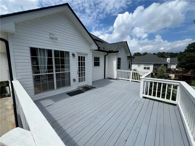 a view of a house with wooden deck