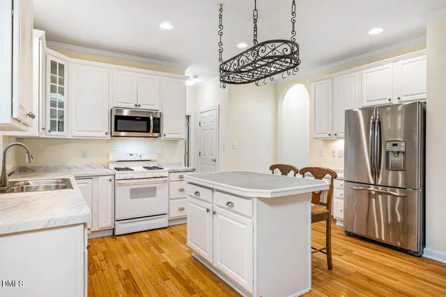a kitchen with a stove a sink and a refrigerator