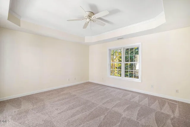 a view of an empty room with a ceiling fan