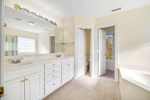 a spacious bathroom with a bathtub and a shower