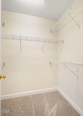 a view of a room that has a window and wooden floor