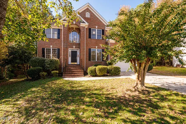 a house that has a tree in front of it