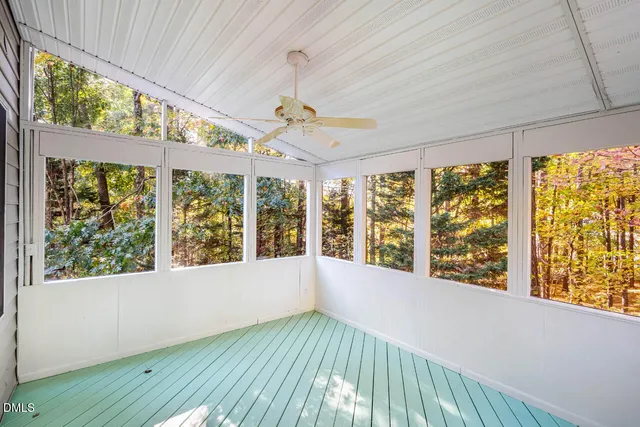 a view of a house with a yard and wooden fence