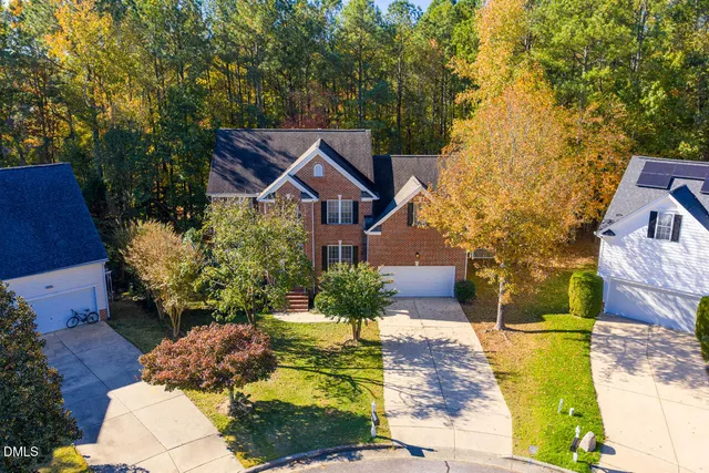 an aerial view of a house with a yard basket ball court and outdoor seating