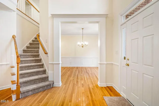 a view of a hallway with wooden floor and staircase