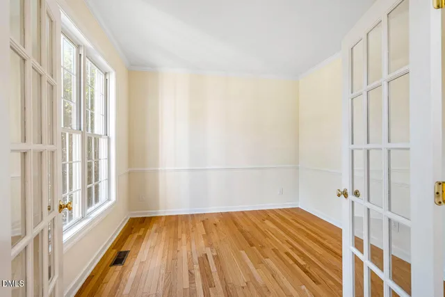 a view of a bedroom with wooden floor and fence