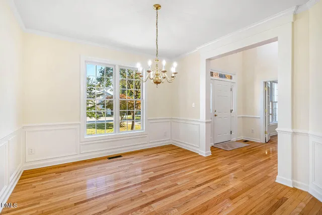 a view of a room with window wooden floor and chandelier