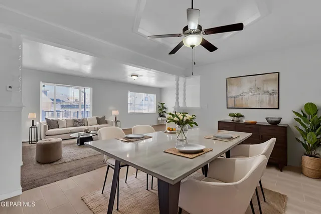 an empty room with chandelier fan