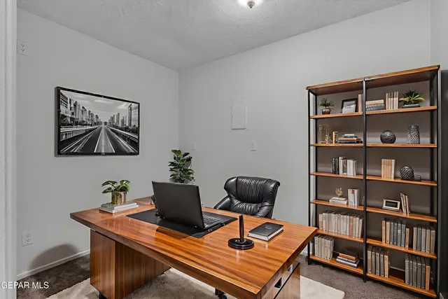 a view of an empty room and a ceiling fan