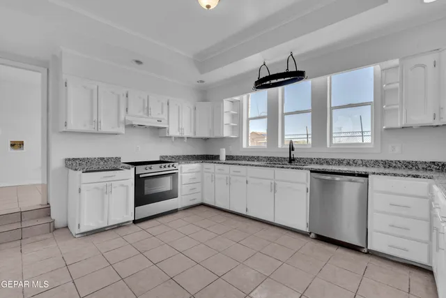 a bathroom with a granite countertop sink a toilet and bathtub