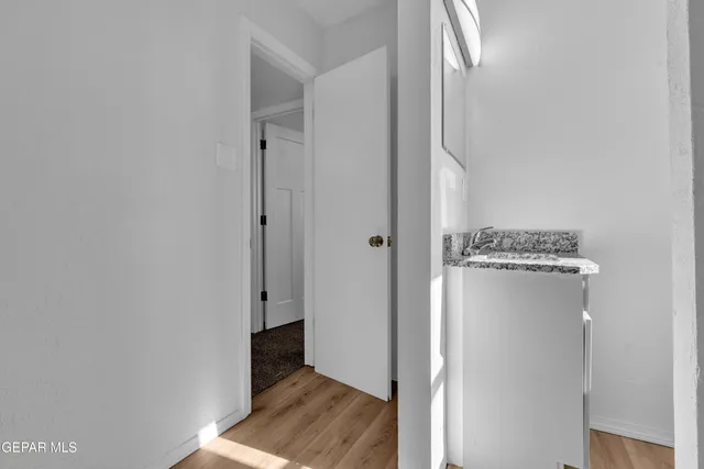 an empty room with a window and a ceiling fan