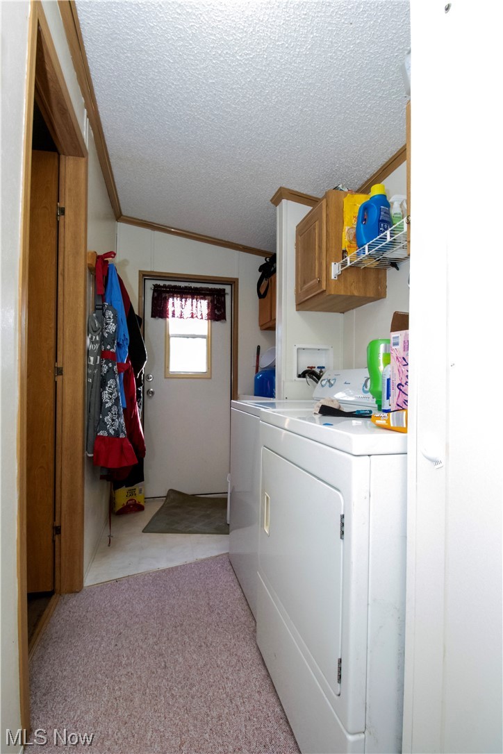 3233 Dover Road Wooster, OH 44691 - Photo 29 of 30 Clothes washing area featuring cabinets, ornamental molding, a textured ceiling, washing machine and dryer, and light carpet