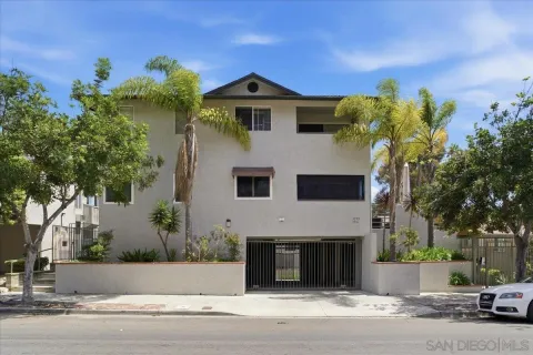 a front view of a house with a garden and plants