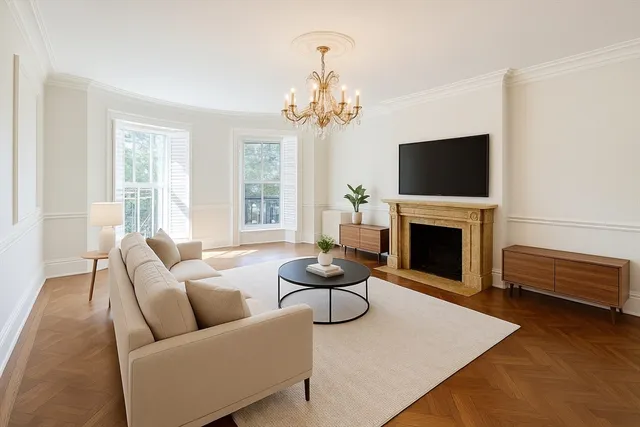 a living room with furniture a fireplace and a flat screen tv