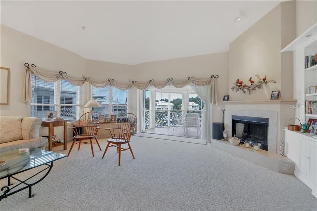11000 Placida Road, Unit 1003 Placida, FL 33946 - Photo 10 of 41 Living room extends out to lanai overlooking marina