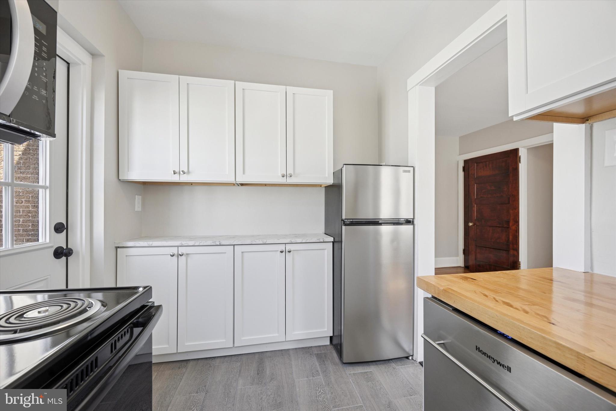 241 Haverford Avenue, Unit 3 Narberth, PA 19072 - Photo 12 of 13 a kitchen with a refrigerator stove and cabinets