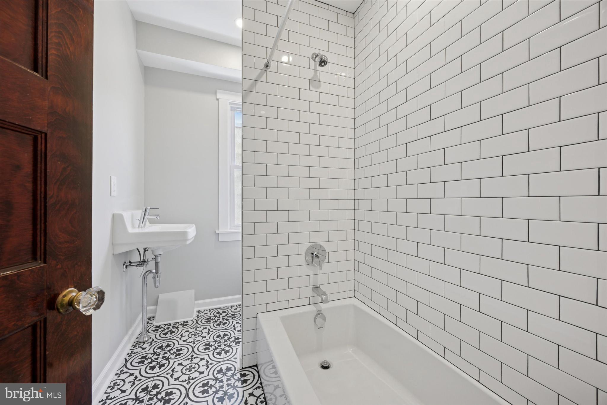 241 Haverford Avenue, Unit 3 Narberth, PA 19072 - Photo 6 of 13 a bathroom with a bathtub and shower