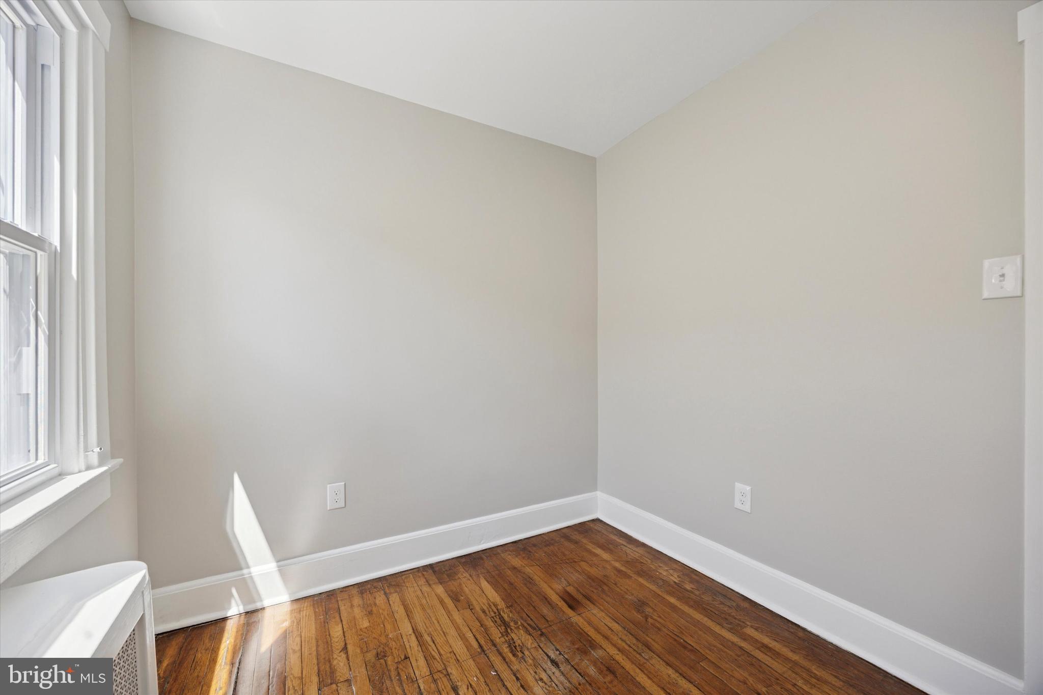 241 Haverford Avenue, Unit 3 Narberth, PA 19072 - Photo 8 of 13 a view of room with window and wooden floor